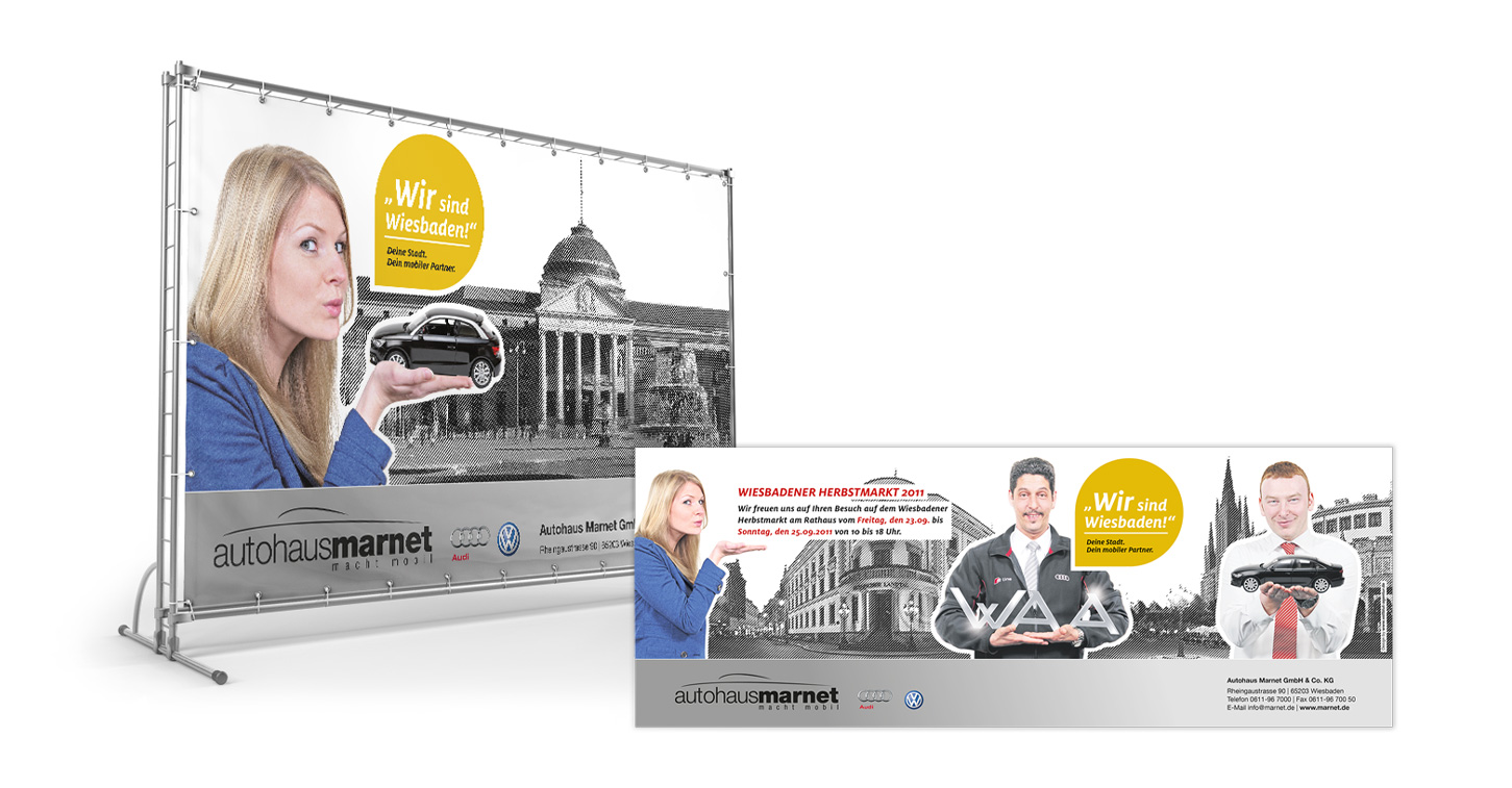 Auf den Werbedisplays für das Vollblut Autohaus Marnet sind Personen mit Spielzeugautos und einem Wahrzeichen der Stadt im Hintergrund zu sehen, mit dem gelben Kreistext „Wir sind Wiesbaden!“ und den Kontaktdaten des Händlers.